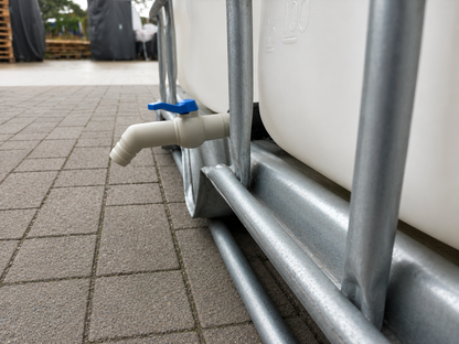 Side view of the replacement IBC tap and extended adapter on a tank; tank not included